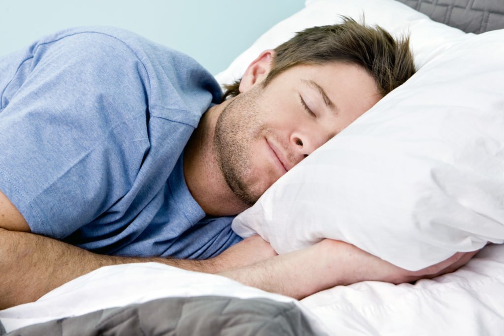 Man sleeping on a comfortable bed